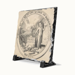 A square decorative tile or plaque with a black-and-beige classical illustration on a rough natural stone base, displayed on a black stand against a light gray background.