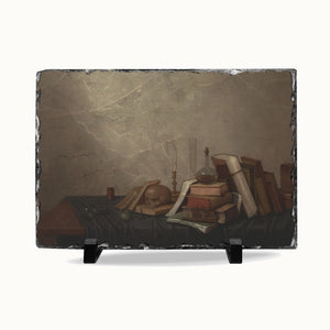 A rectangular slate serving board with a printed still life artwork of old books, a skull, candles, and a glass vessel on a dark table, displayed on a white background with two small black stands.