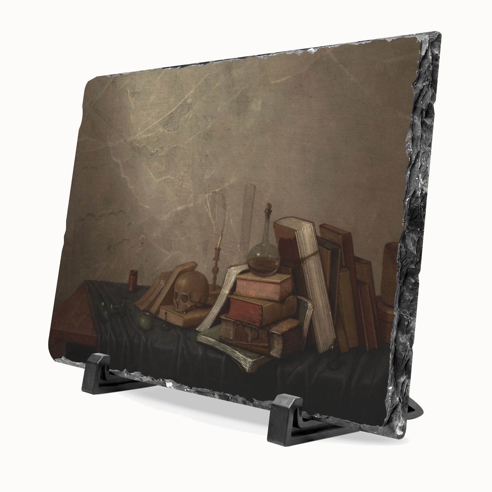 A rectangular slate sign with a still life painting print of old books, a skull, and a glass flask, displayed on a black stand against a light background.