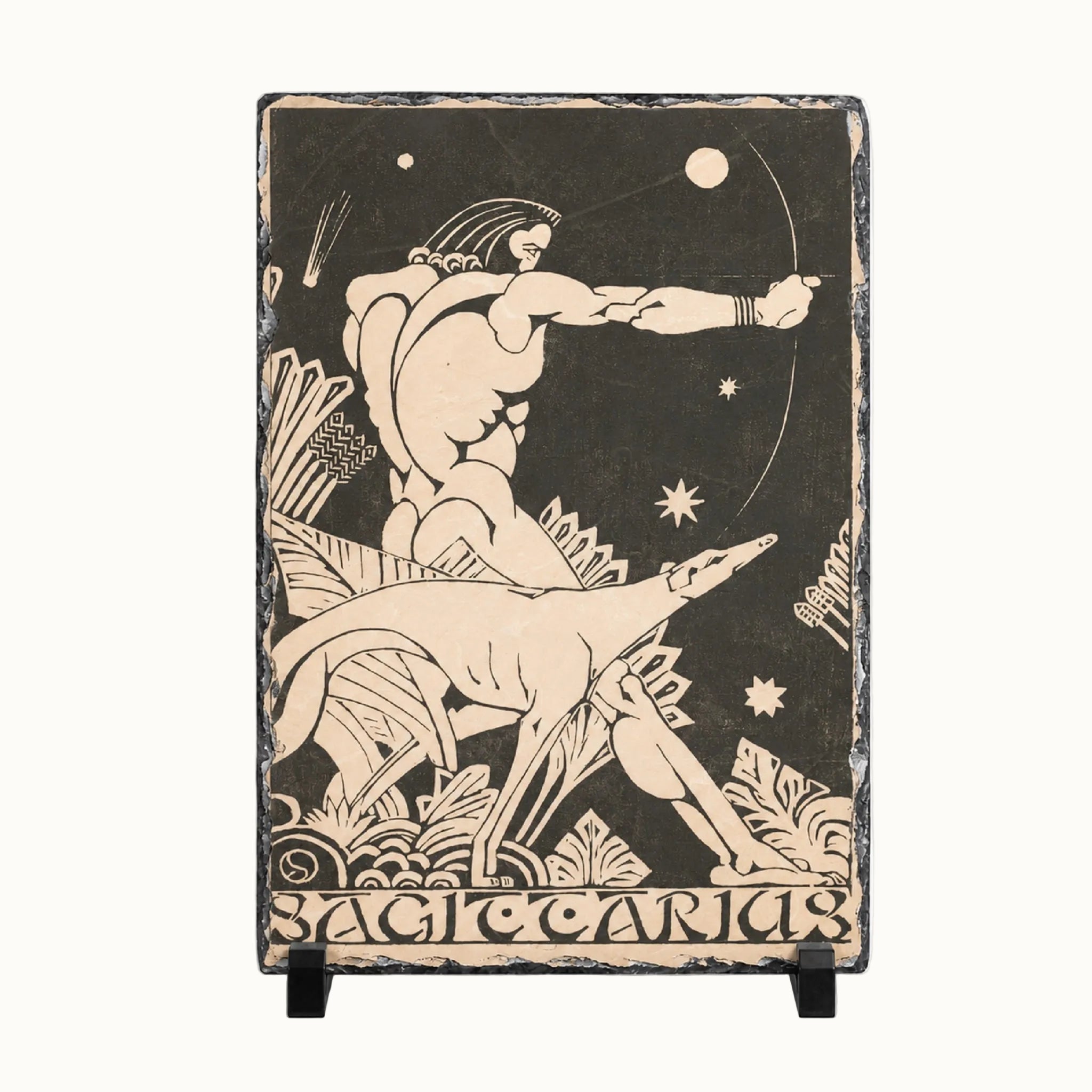 A rectangular decorative wall plaque or sign with a black background and cream-colored relief-style artwork showing a nude male figure drawing a bow while a dog stands beside him. The bottom edge reads 'SACROCANIS.