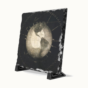 A rectangular black slate coast sign featuring a vintage-style map of the Earth, displayed on a black stand against a white background.