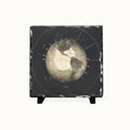 A square black slate coaster or decorative tile featuring an antique-style vintage globe map print, displayed on a small black stand against a clean white background.
