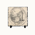 A square decorative slate tile with a black-and-white classical illustration of a figure and the text 'GLORIA MUNDI', displayed on a small black stand against a plain white background.