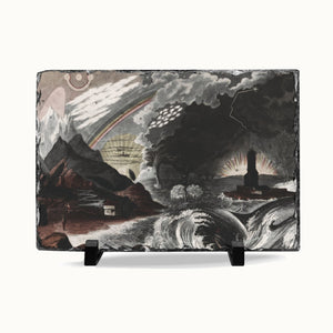 A rectangular slate art plaque displaying a dramatic landscape painting with a stormy sky, rainbow, mountains, waves, and a lighthouse, shown on a light gray background with two small black display feet.
