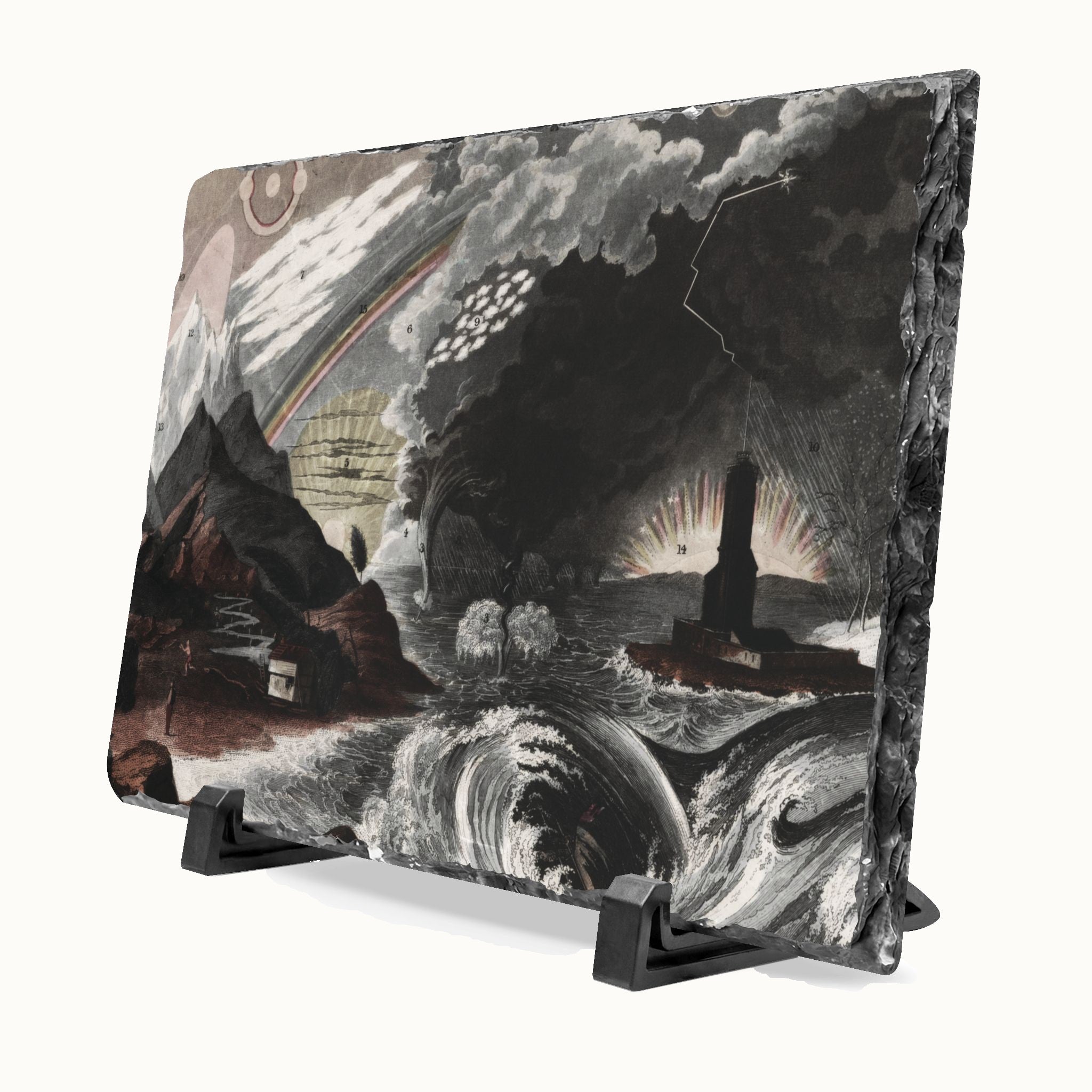 A square slate art plaque featuring a dramatic monochrome seascape painting with storm clouds, waves, mountains, and a lighthouse, displayed on a black stand against a white background.