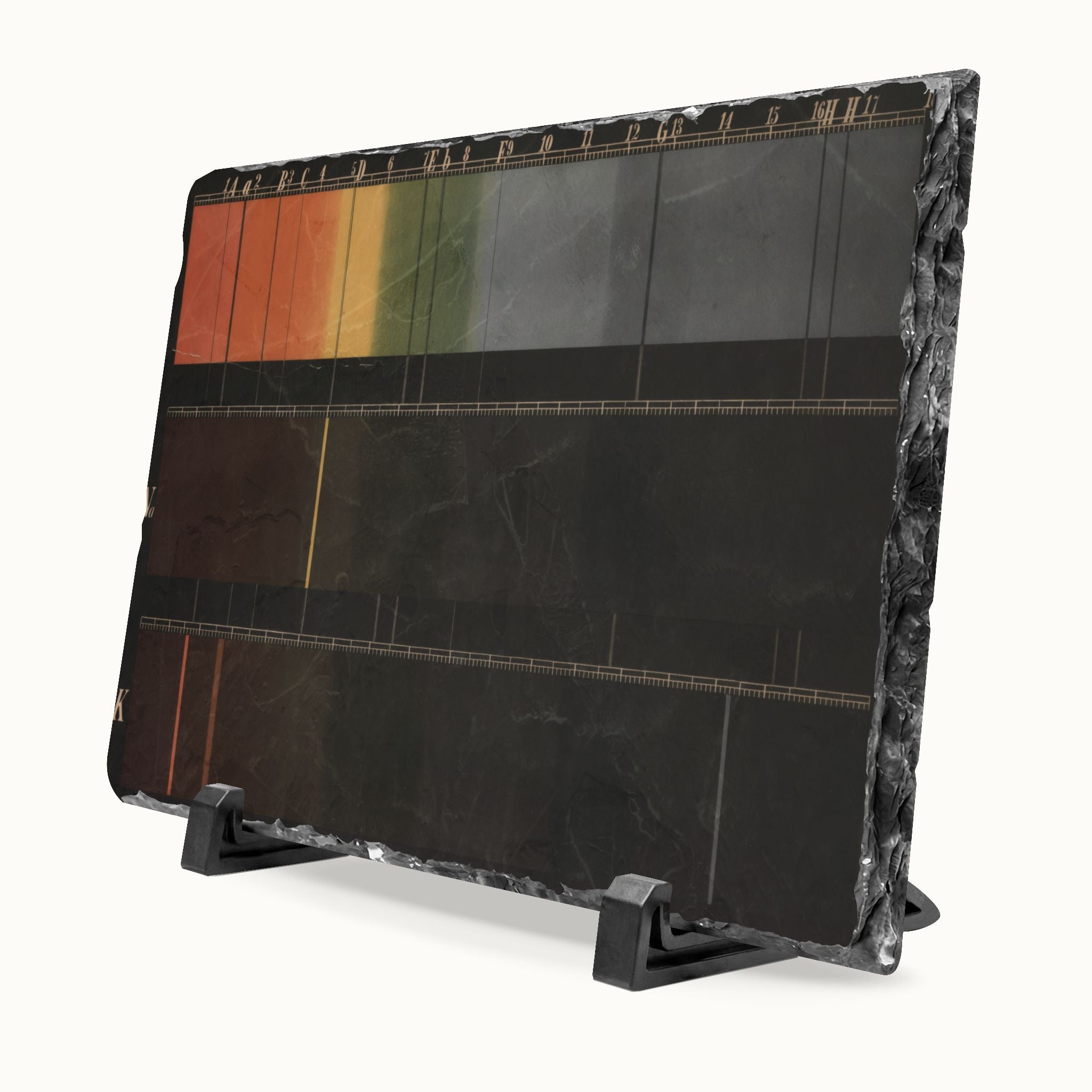A rectangular black stone slate art plaque on a black display stand, featuring a horizontal gradient design transitioning from orange and green at the top to solid black at the bottom, with fine gold lines.